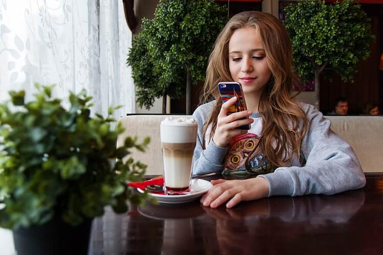 woman-using-phone-in-cafe.jpg